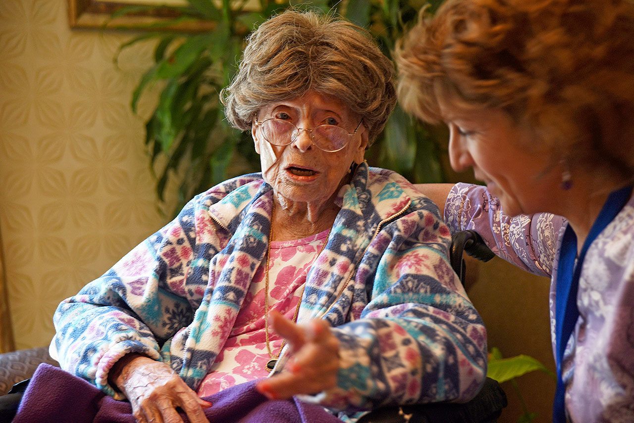 Adele Dunlap (left) talks with Susan Dempster, the activities director at the Country Arch Care Center in Pittstown, New Jersey, in July 2016. Dunlap, a 114-year-old New Jersey woman who was believed to be the oldest person in the U.S., died Sunday. (Chris Pedota/The Record via AP, File)