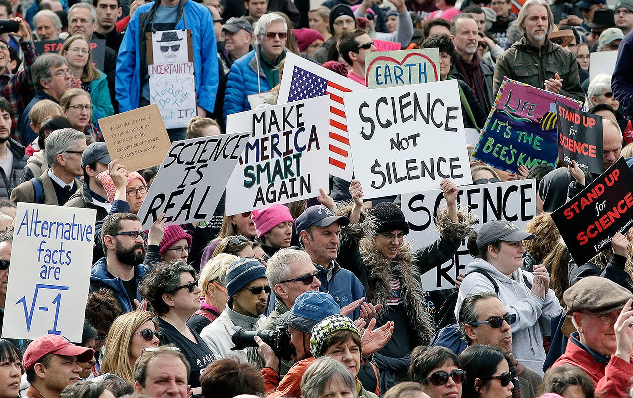 Members of the scientific community, environmental advocates and supporters demonstrate Sunday in Boston to call attention to what they say are the increasing threats to science and scientific research under the administration of President Donald Trump. (Steven Senne / Associated Press)