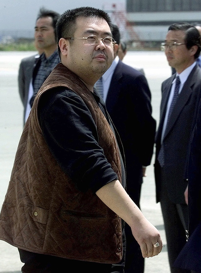 In this May 4, 2001, photo, a man believed to be Kim Jong Nam, the eldest son of then North Korean leader Kim Jong Il, looks at a battery of photographers as he exits a police van to board a plane to Beijing at Narita international airport in Narita, northeast of Tokyo. Malaysian officials say a North Korean man has died after suddenly becoming ill at Kuala Lumpur’s airport. (AP Photo/Shizuo Kambayashi, File)