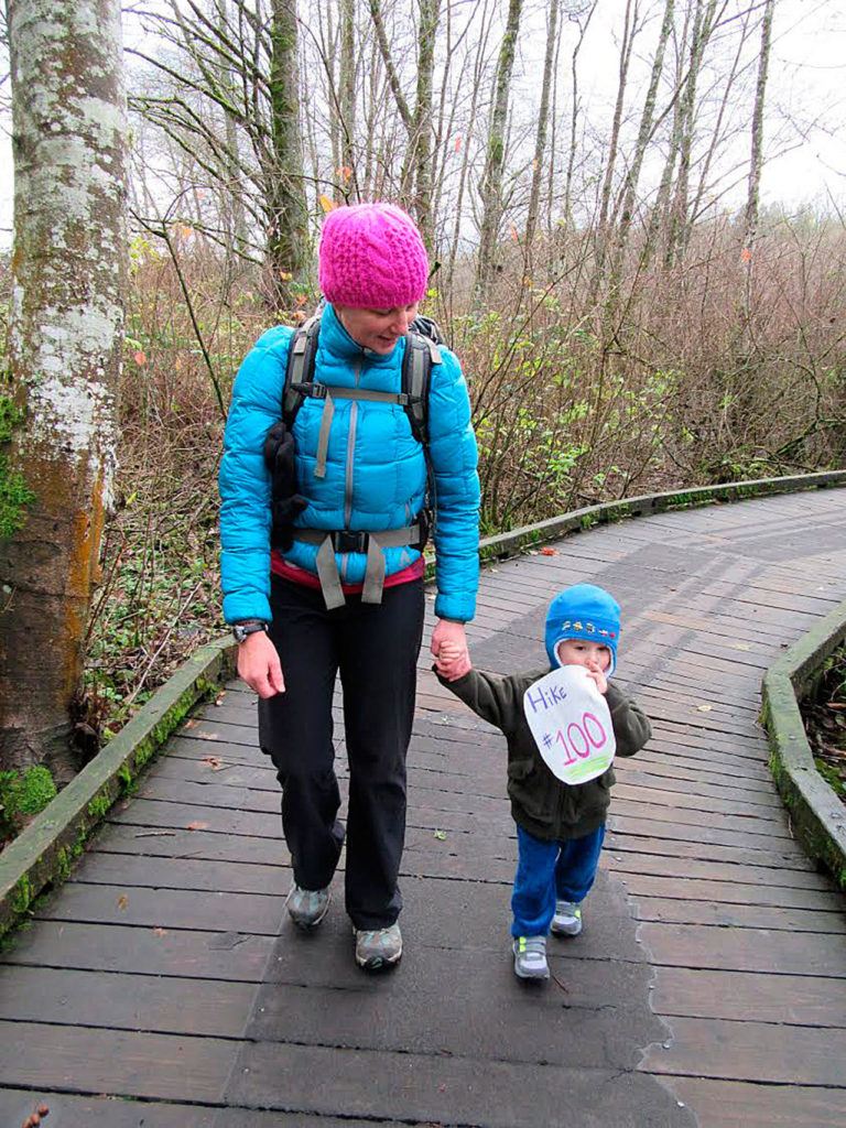 Heather Romano walks with Giovanni Romano on his 100th hike, shortly before his second birthday. (Craig Romano)

