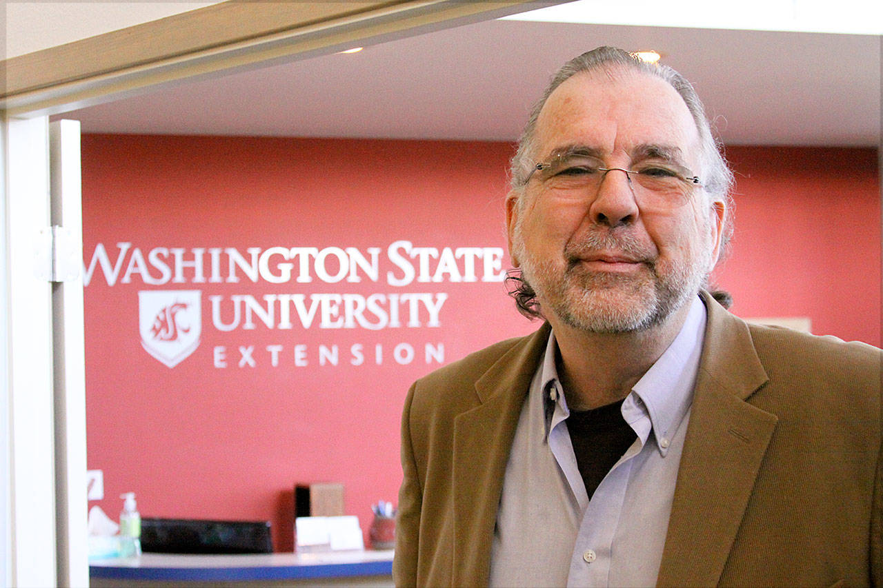 Dr. Tim Lawrence, director of Washington State University’s Island County Extension in Coupeville, explains how a conference room will be used for WSU classes using video-conferencing equipment. (Photo by Ron Newberry / Whidbey News-Times)