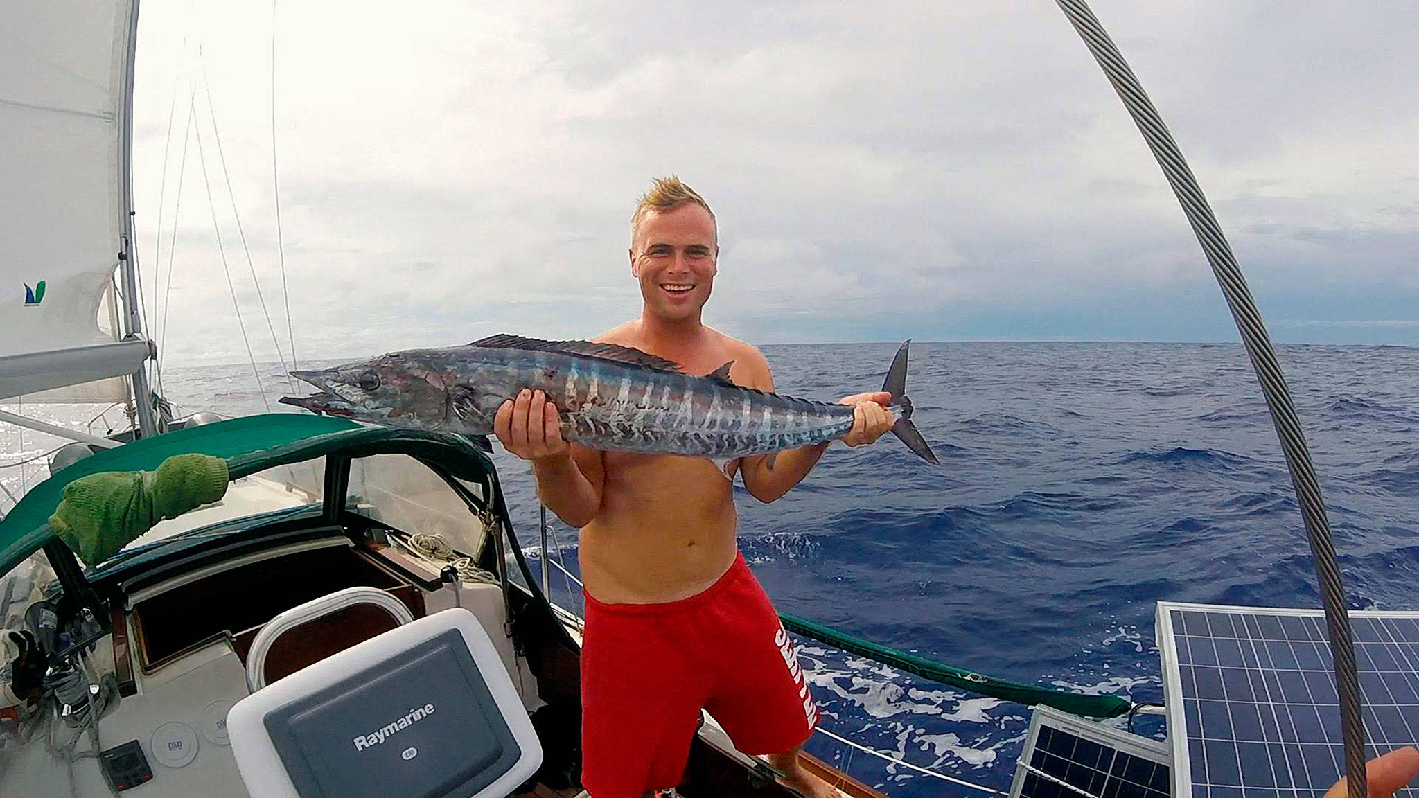 Andy Stephens holds a Wahoo fish caught from his 30-foot sailboat about 100 miles west of Pohnpei, Micronesia, in the Pacific. The 33-year-old Everett native left on a round-the-world sailing trip in July. He is home in Everett this month, but will soon fly back to the Philippines where his boat is now moored. (Courtesy Andy Stephens)