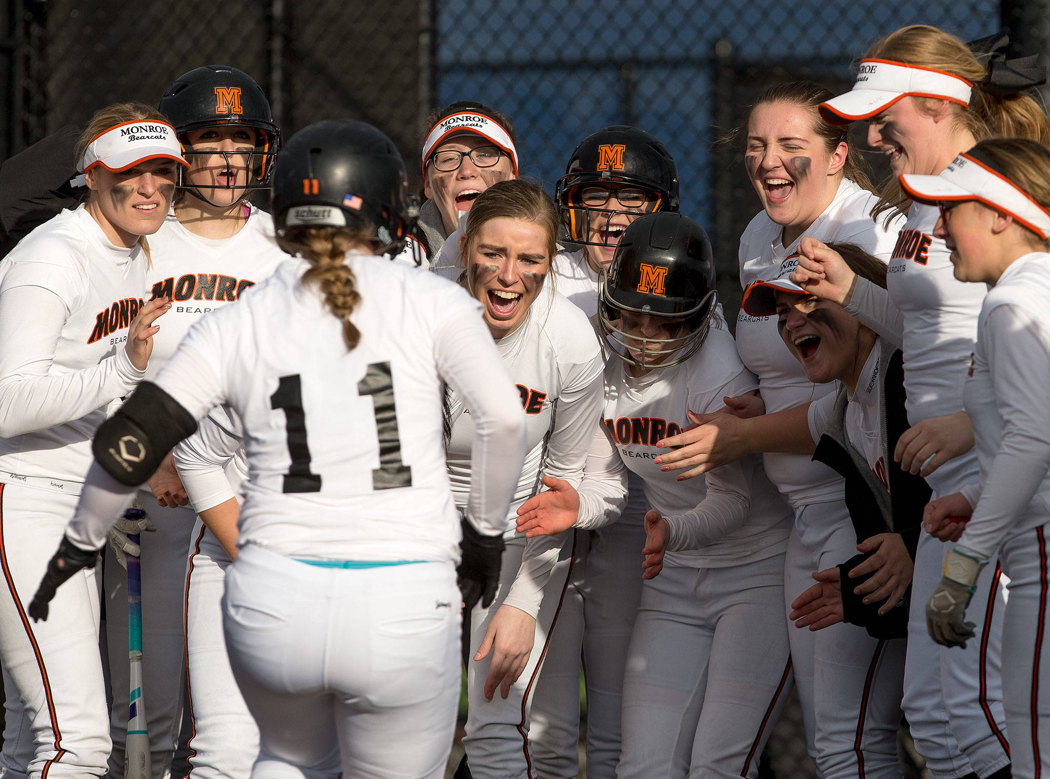 Monroe players cheer as McKenzie Schulz (11) runs to home plate after hitting a two-run home run to tie the game in the seventh inning against Edmonds-Woodway on March 21, 2017, in Monroe. The Bearcats went on to beat Edmonds-Woodway 3-2 in extra innings. (Andy Bronson / The Herald)