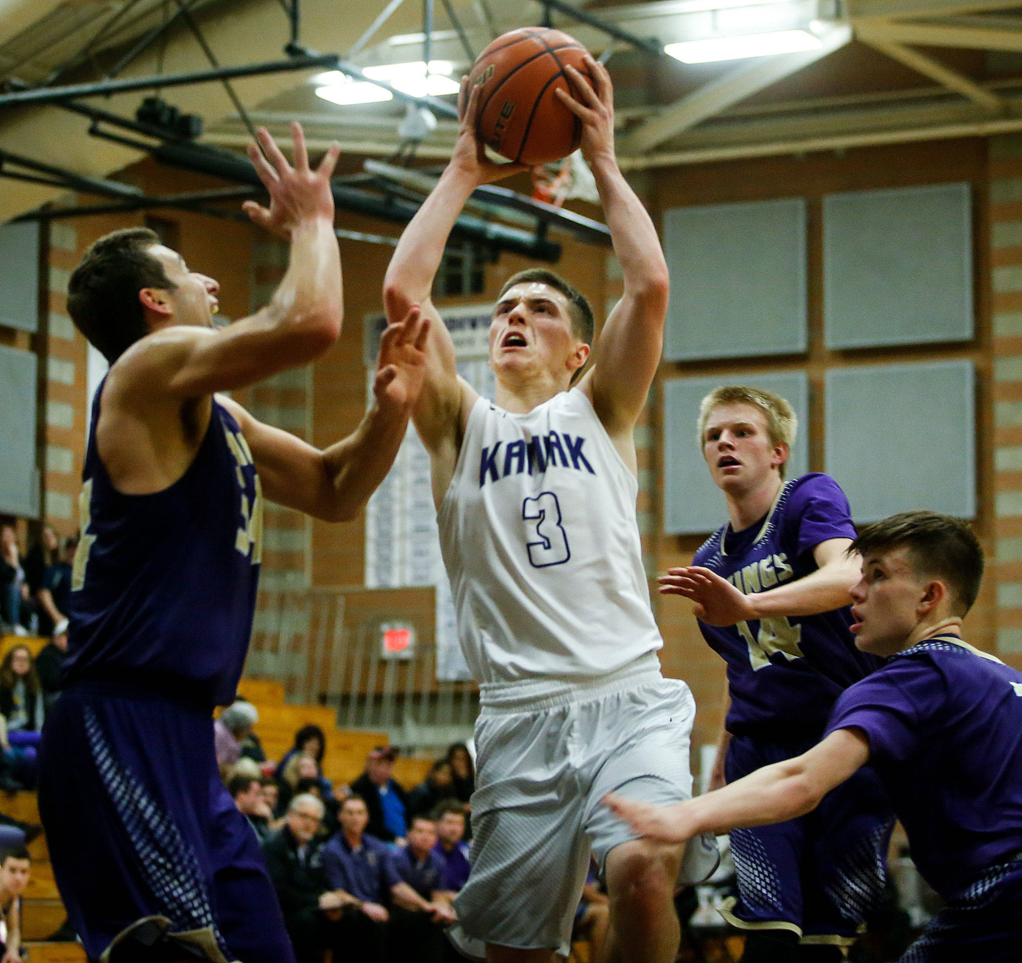Kamiak’s Carson Tuttle (3) weaves past Lake Stevens defenders during a game in January in Mukilteo. The junior guard was named to the Class 4A All-State first team Monday by Associated Press. (Ian Terry / The Herald)