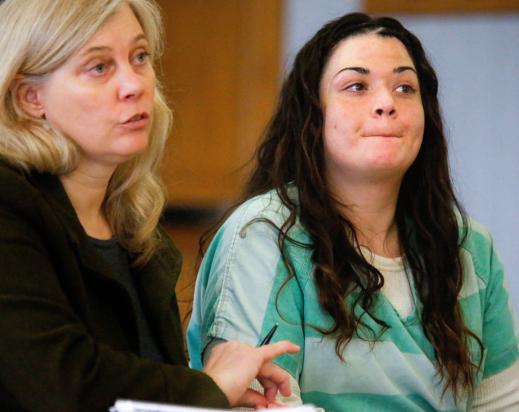 Snohomish County public defender Jennifer McIntyre discusses details of sentencing Thursday with Superior Court Judge Linda Krese as Gabrielle Waller listens.Waller will have 13 months remaining on her 20-month sentence when she returns to jail for selling heroin to Ian Digre. She refusedthe opportunity to speak to his family. (Dan Bates / The Herald)