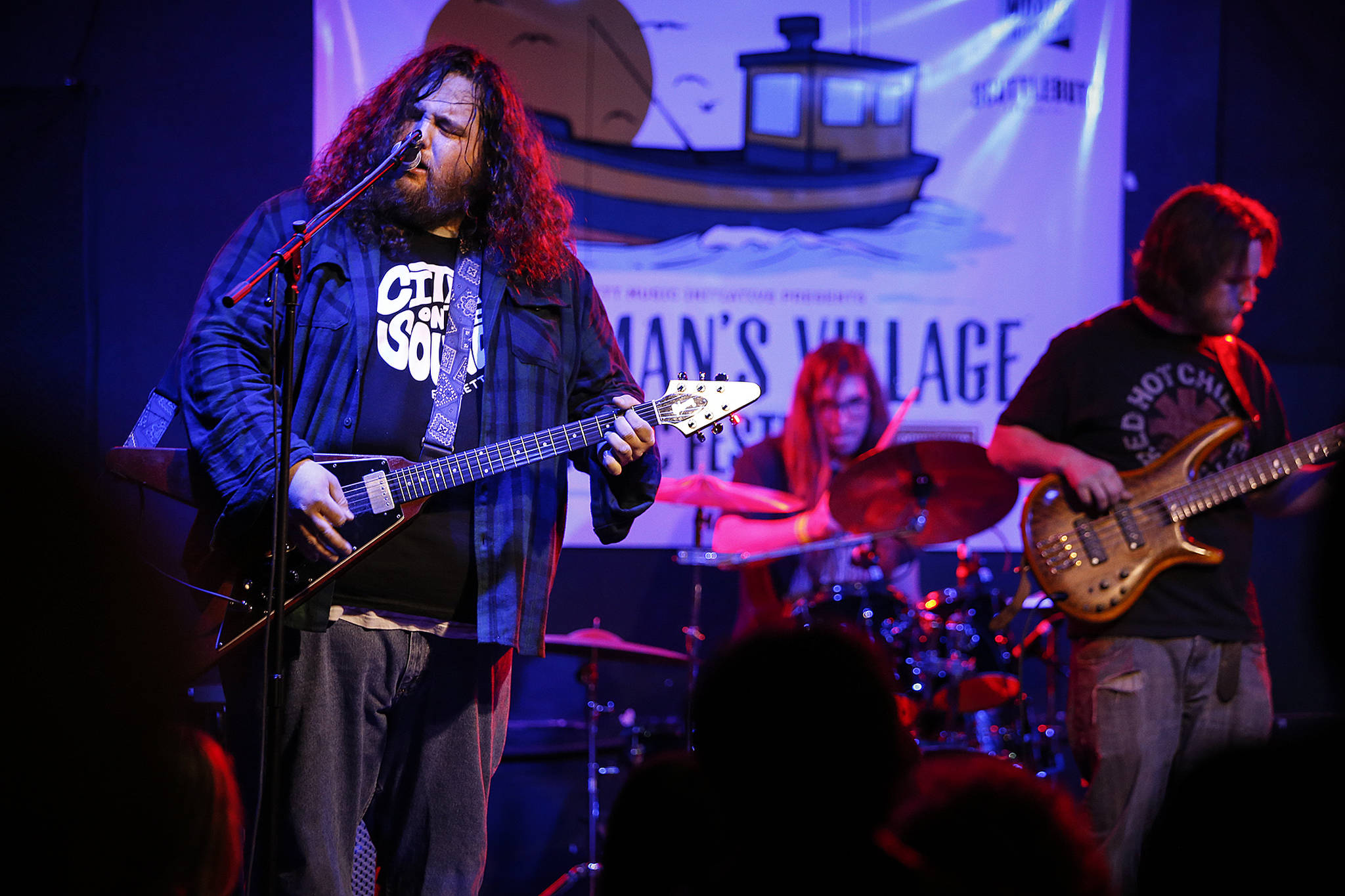 Kirk Rutherford (left) sings during a set of music from the Everett band The Moon Is Flat at Tony V’s during the opening night of the Fisherman’s Village Music Festival in Everett on Friday, March 31. (Ian Terry / The Herald)