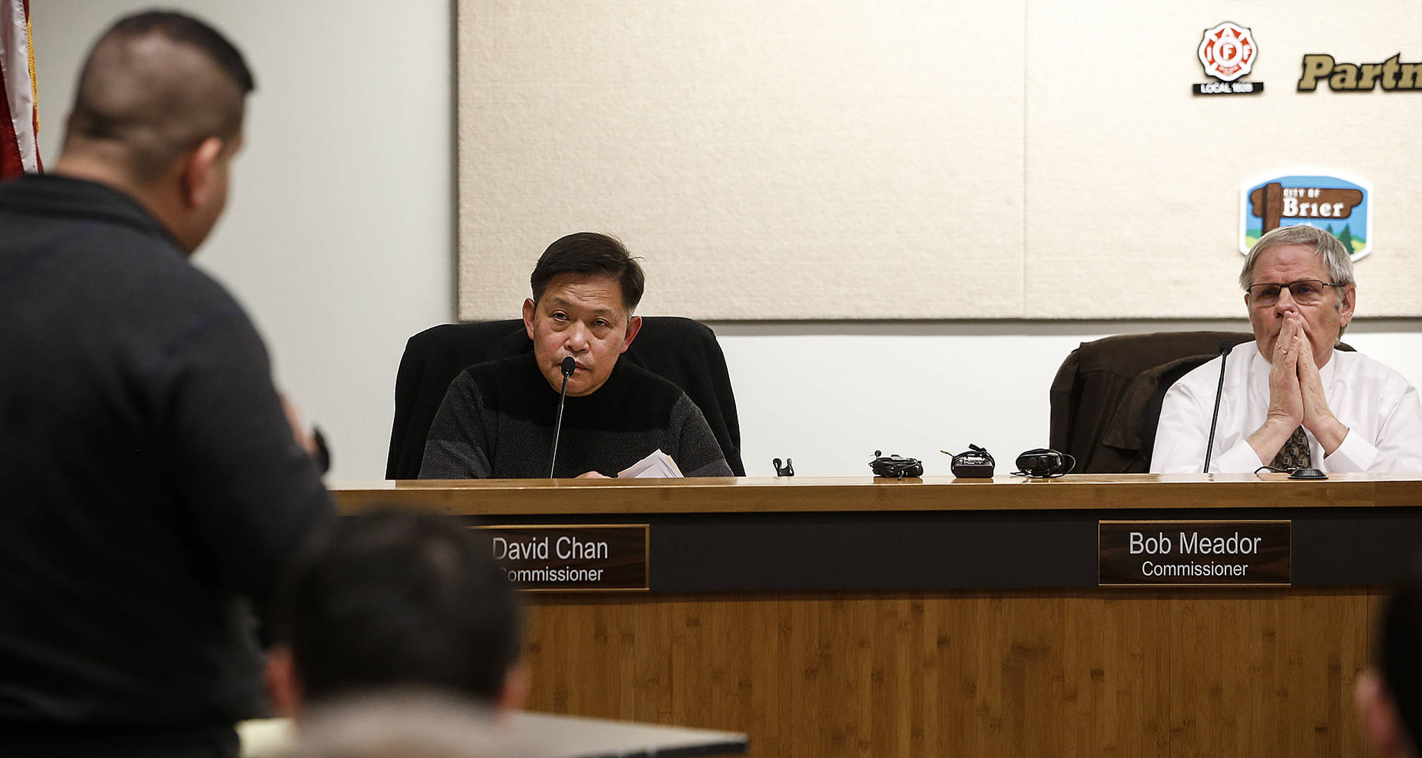 Jimmy Matta (left) addresses Commissioners David Chan (center left) and Bob Meador during a meeting at Fire District 1 in Everett on Tuesday. (Ian Terry / The Herald)