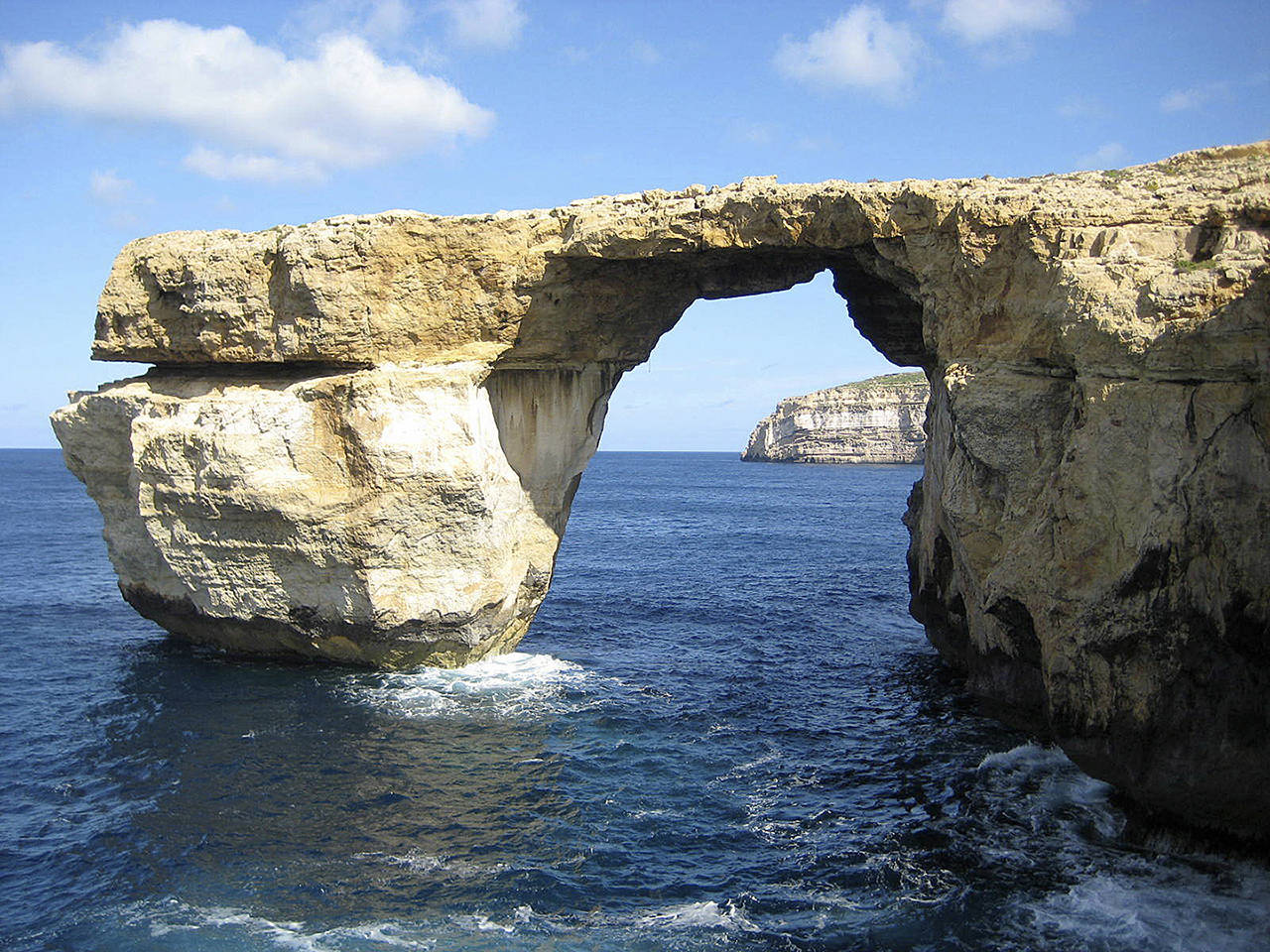This is a April 2014 image of the landmark the Azure Window located just off Malta. The natural rock arch jutting off the Maltese island of Gozo has collapsed into the sea during a storm. No one was injured by the fallen arch, which was also a TV and film backdrop. (Caroline Hodgson via AP)