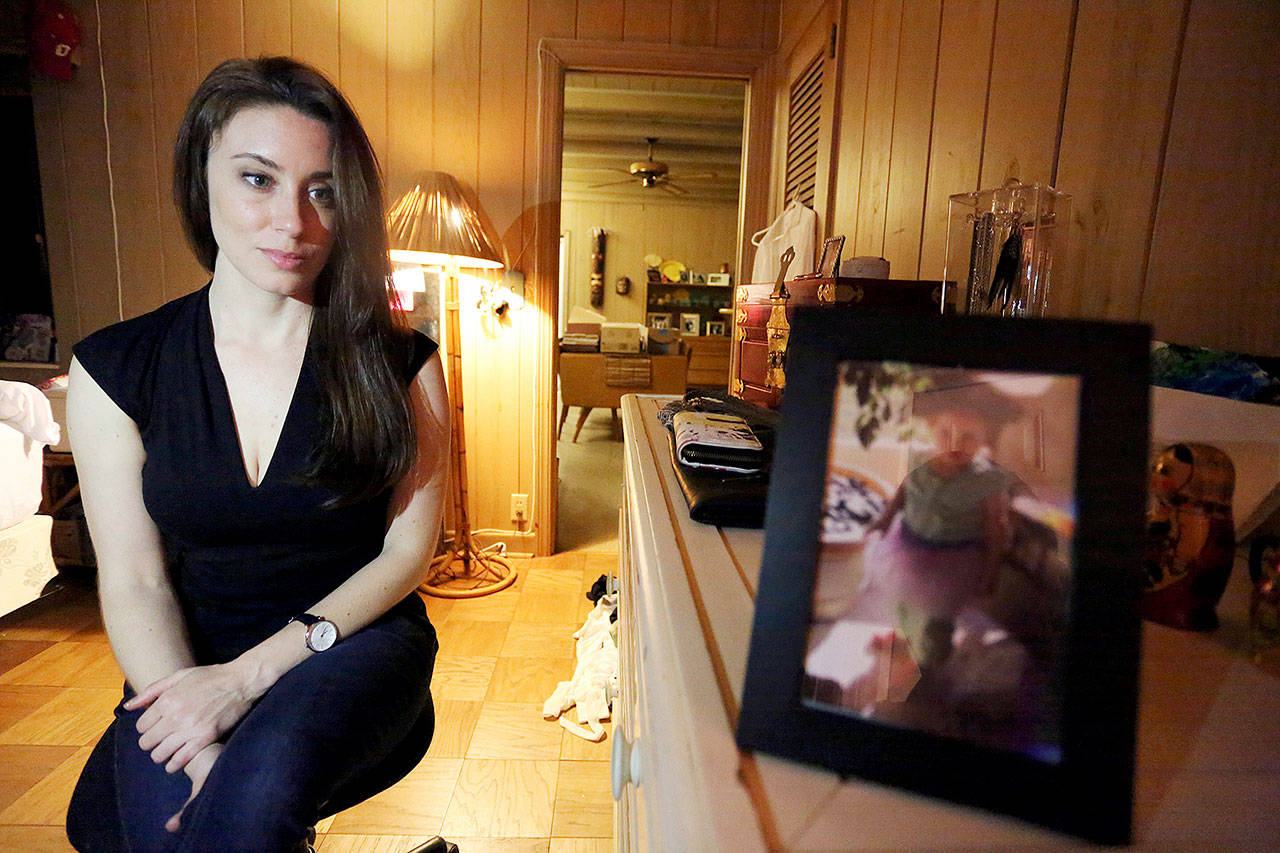 Casey Anthony poses for a portrait next to a photo of her daughter, Caylee, in her West Palm Beach, Florida, bedroom. (AP Photo/Joshua Replogle)