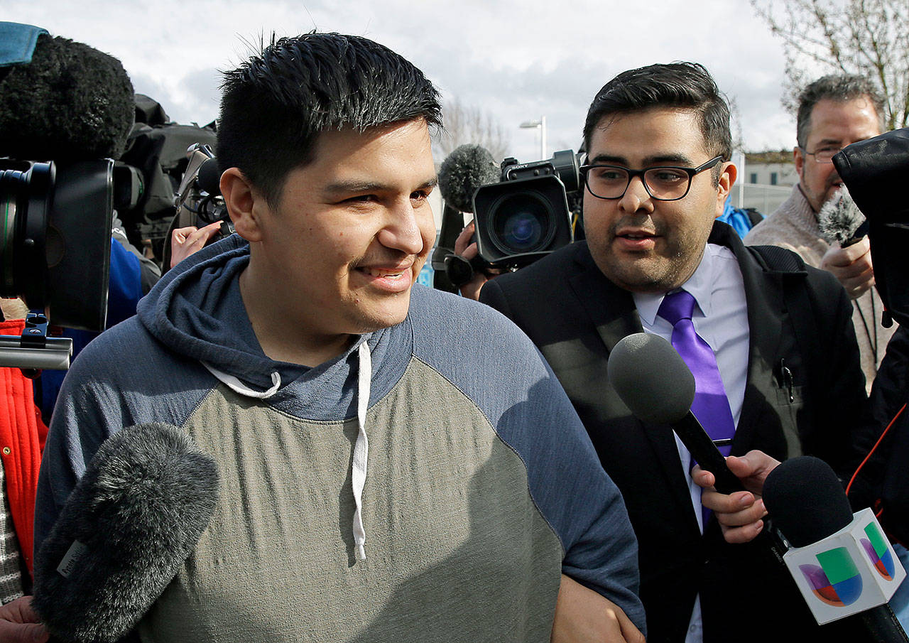 Daniel Ramirez Medina (center) talks to reporters as he walks with his attorney, Luis Cortes (right), after Ramirez was freed from custody at the Northwest Detention Center in Tacoma on Wednesday. Ramirez had spent more than six weeks in immigration detention despite his participation in a program designed to prevent the deportation of those brought to the U.S. illegally as children. (AP Photo/Ted S. Warren)