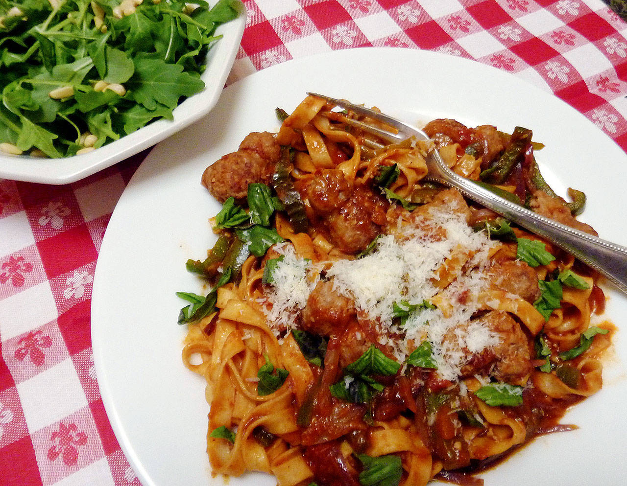 This fettuccini dish features pepper, onion and sausage in pasta sauce. (Linda Gassenheimer / TNS)