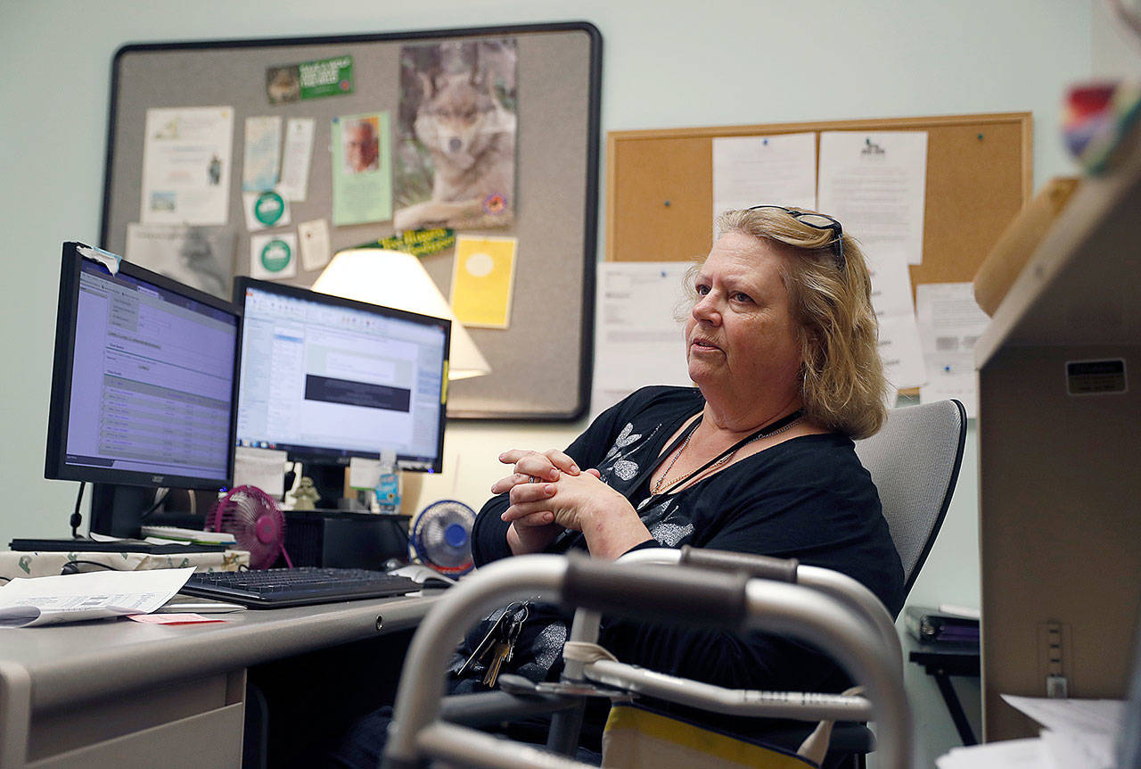 Mary Lytle-Gaines works in her office in St. Louis on Tuesday. The 61-year-old social worker had hoped to semi-retire next year. (AP Photo/Jeff Roberson)