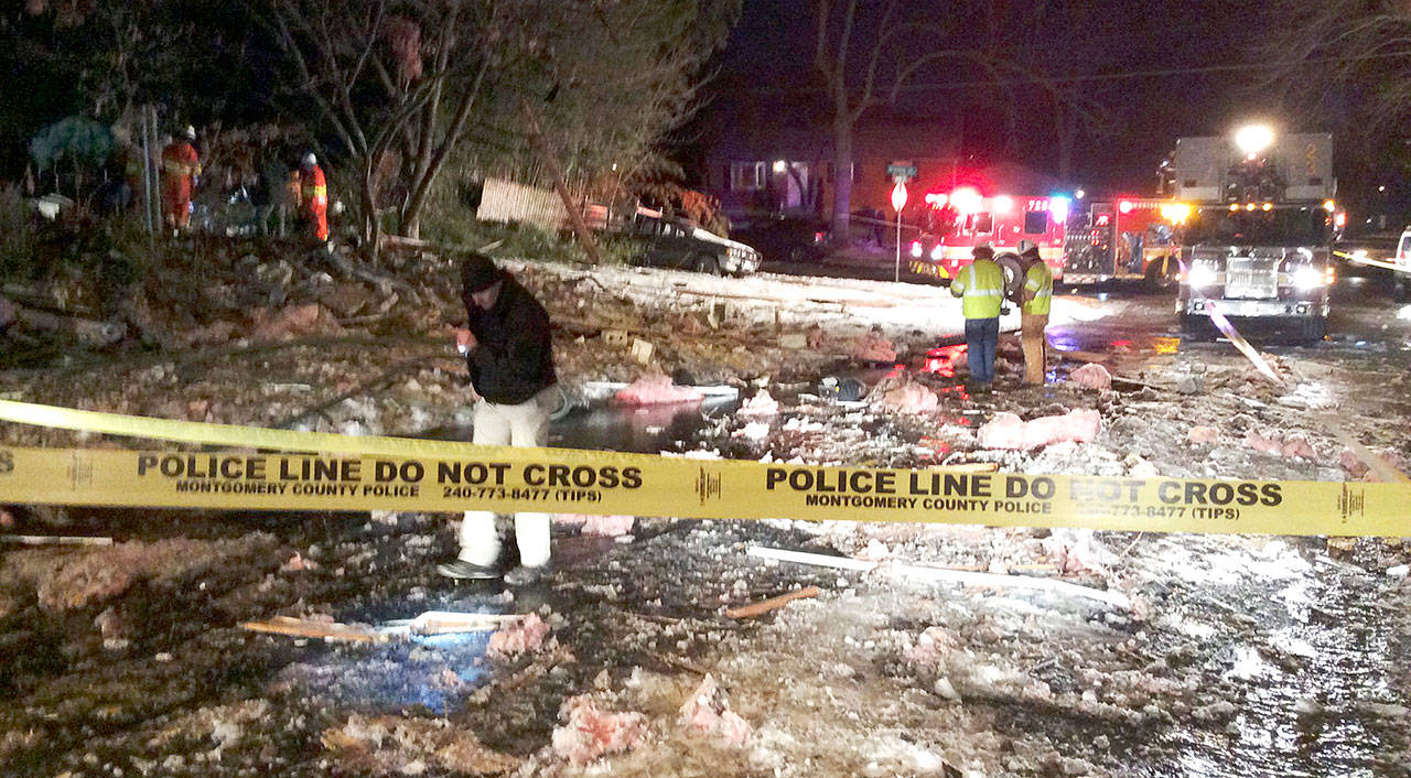 Emergency personnel work at the scene of a leveled house in Rockville, Maryland, on Friday. (Montgomery County Fire & Rescue Service via AP)