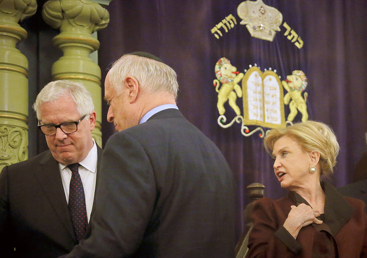 Jonathan Miller (left), NYPD deputy commissioner of Intelligence and Counterterrorism, Malcolm Hoenlein (center), executive vice-chair of Conference of Presidents of Major Jewish Organizations, and Congresswoman Carolyn Maloney, member of Congress’ bipartisan task force combating anti-Semitism, confer after holding a news conference to address bomb treats against Jewish organizations and vandalism at Jewish cemeteries, Friday March 3, at the Park East Synagogue in New York. (AP Photo/Bebeto Matthews)