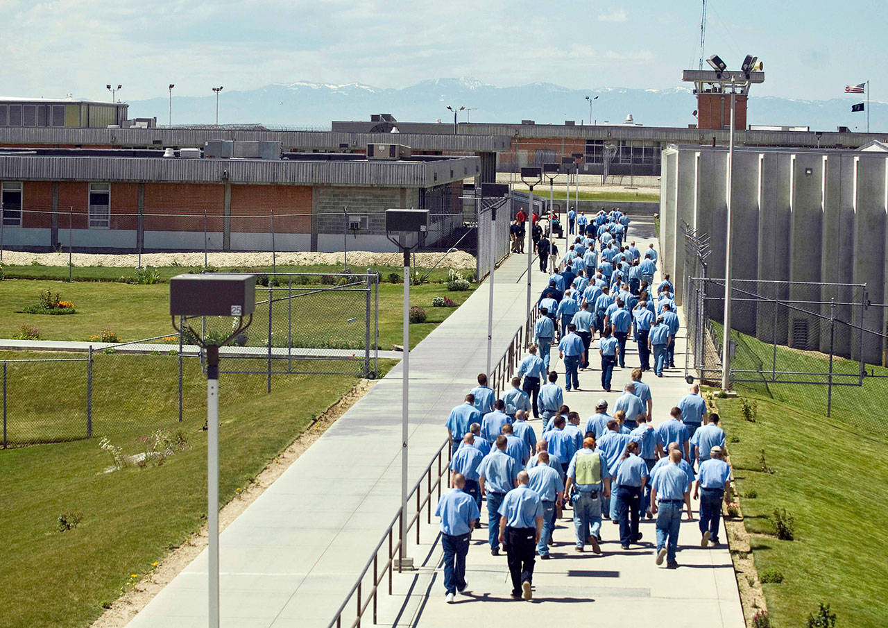 In this 2010 photo, inmates walk to the dinning hall from their cell block at the Idaho State Correctional Institution outside Boise, Idaho. Idaho inmates are asking a federal judge to hold the state in contempt after they say prison officials repeatedly violated a settlement plan in a long-running lawsuit over health care, leading to serious injuries and even the deaths of some prisoners. (Charlie Litchfield / AP File)