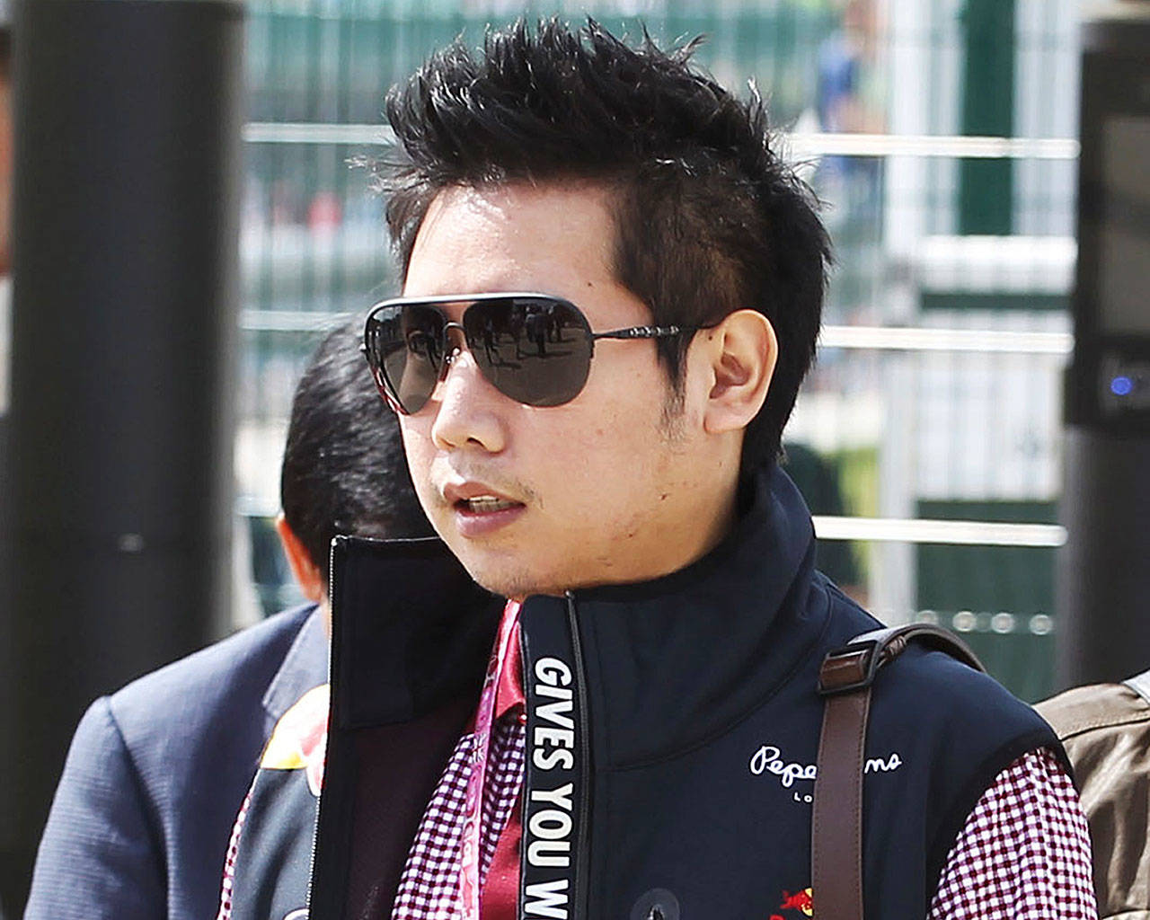 In this June 30, 2013, photo provided by XPB Images, Vorayuth “Boss” Yoovidhya walks at the British Formula 1 Grand Prix in Silverstone, England. Vorayuth is accused of killing a Thai police officer in a hit-and-run in 2012, yet he still has not appeared to face charges. (XPB Images via AP)