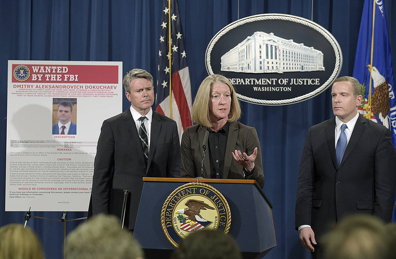 Acting Assistant Attorney General Mary McCord (center), accompanied by U.S. Attorney for the Northern District Brian Stretch (left) and FBI Executive Director Paul Abbate, speaks during a news conference at the Justice Department in Washington on Wednesday, March 15. (AP Photo/Susan Walsh)