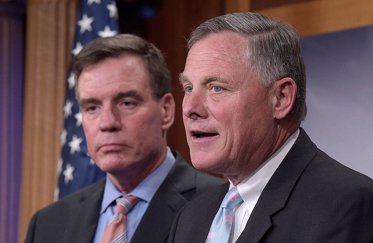 Senate Intelligence Committee Chairman Sen. Richard Burr, R-N.C. (right), and the committee’s Vice Chairman Sen. Mark Warner, D-Va., discuss the committee’s investigation of Russian interference in the 2016 election Wednesday. (AP Photo/Susan Walsh)