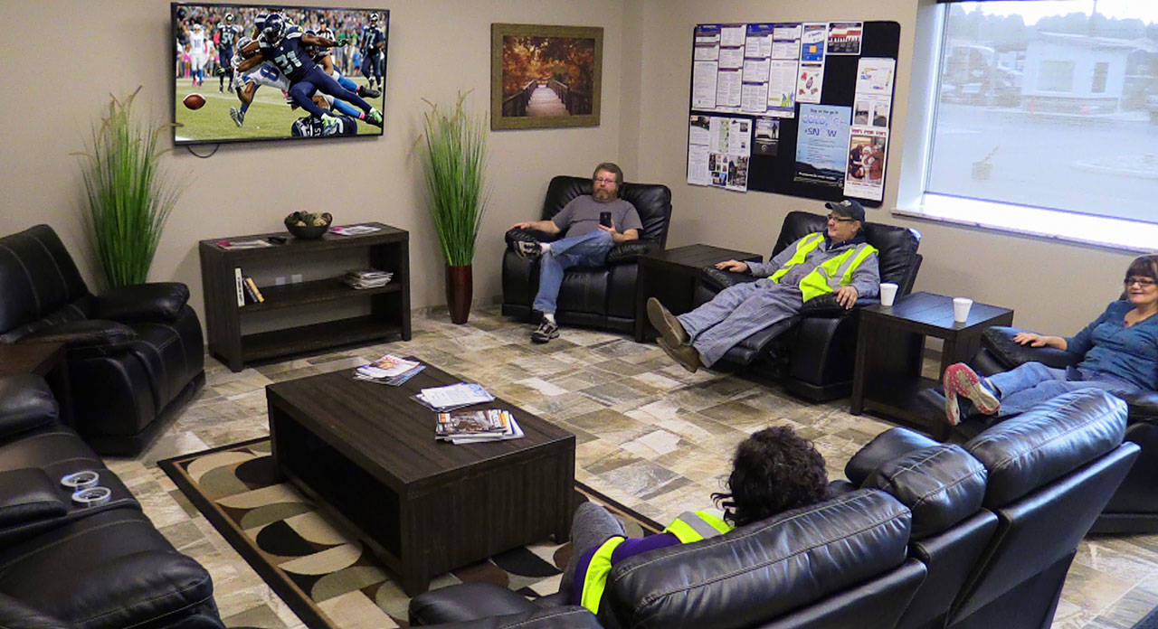 A lounge for drivers at Smokey Point Distributing in Arlington offers a reclining sectional and a large-screen television. (Contributed photo)