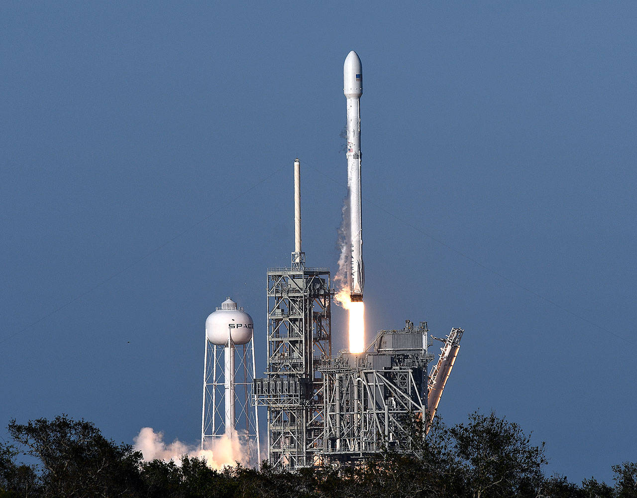 A SpaceX Falcon 9 rocket lifts off from Kennedy Space Center in Cape Canaveral, Florida, on Thursday. SpaceX launched its first recycled rocket, the biggest leap yet in its bid to drive down costs and speed up flights. (Craig Bailey/Florida Today via AP)