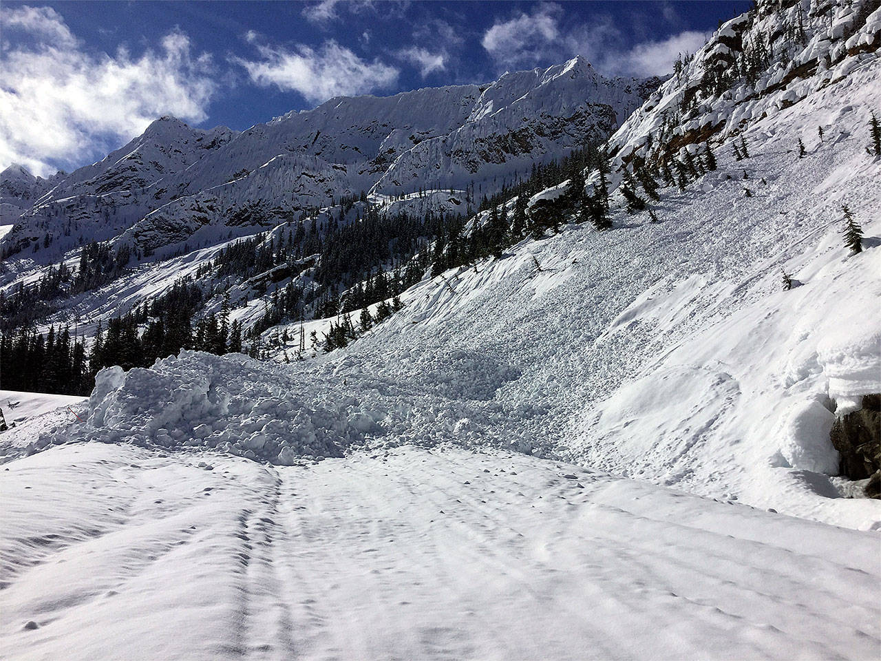 Washington State Department of Transportation avalanche technicians ventured into the closed section of Highway 20 on March 16 to assess conditions, snow levels and safety risks, including this slide near Liberty Bell Mountain. Crews hope to begin clearing the highway in April after the threat of further avalanches has passed. (WSDOT photo)