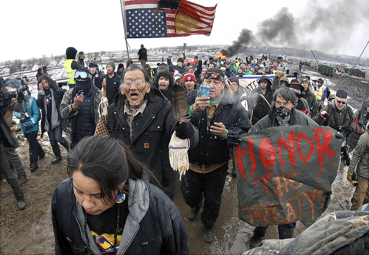 In this Feb. 22 photo, a large crowd representing a majority of the remaining Dakota Access Pipeline protesters march out of the Oceti Sakowin camp before the 2 p.m. local time deadline set for evacuation of the camp mandated by the U.S. Army Corps of Engineers near Cannon Ball, North Dakota. (Mike McCleary/The Bismarck Tribune via AP, File)