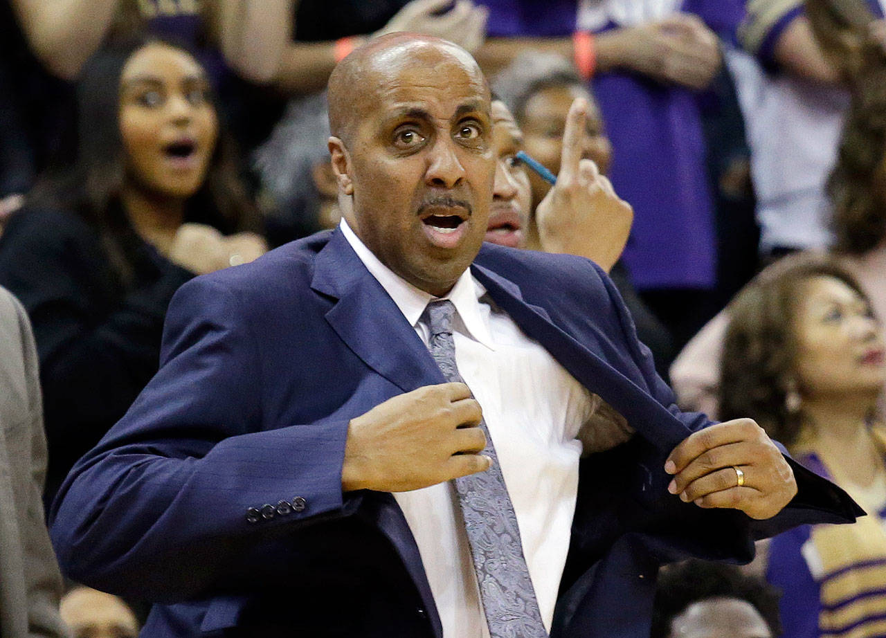 Washington head coach Lorenzo Romar pulls on his jacket as a call goes in favor of Arizona late in the second half of a game Feb. 18, 2017, in Seattle. Arizona won 76-68. (AP Photo/Elaine Thompson)