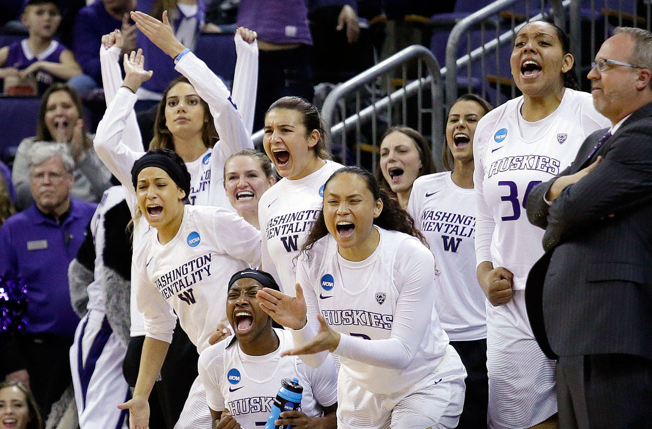 Players on the Washington bench cheer a score against Montana State during the first half of an NCAA Tournament game March 18, 2017, in Seattle. (AP Photo/Elaine Thompson)