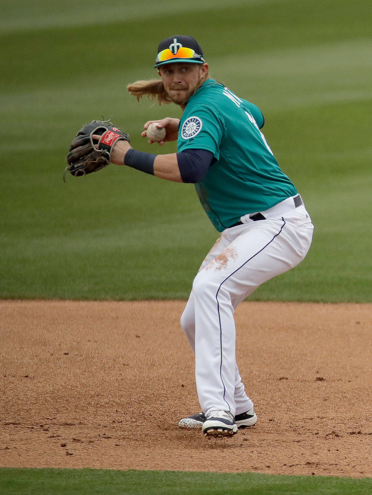 Mariners second baseman Taylor Motter throws to first during the first inning of a spring training game against the Royals on Feb. 27, 2017, in Peoria, Ariz. (AP Photo/Charlie Riedel)