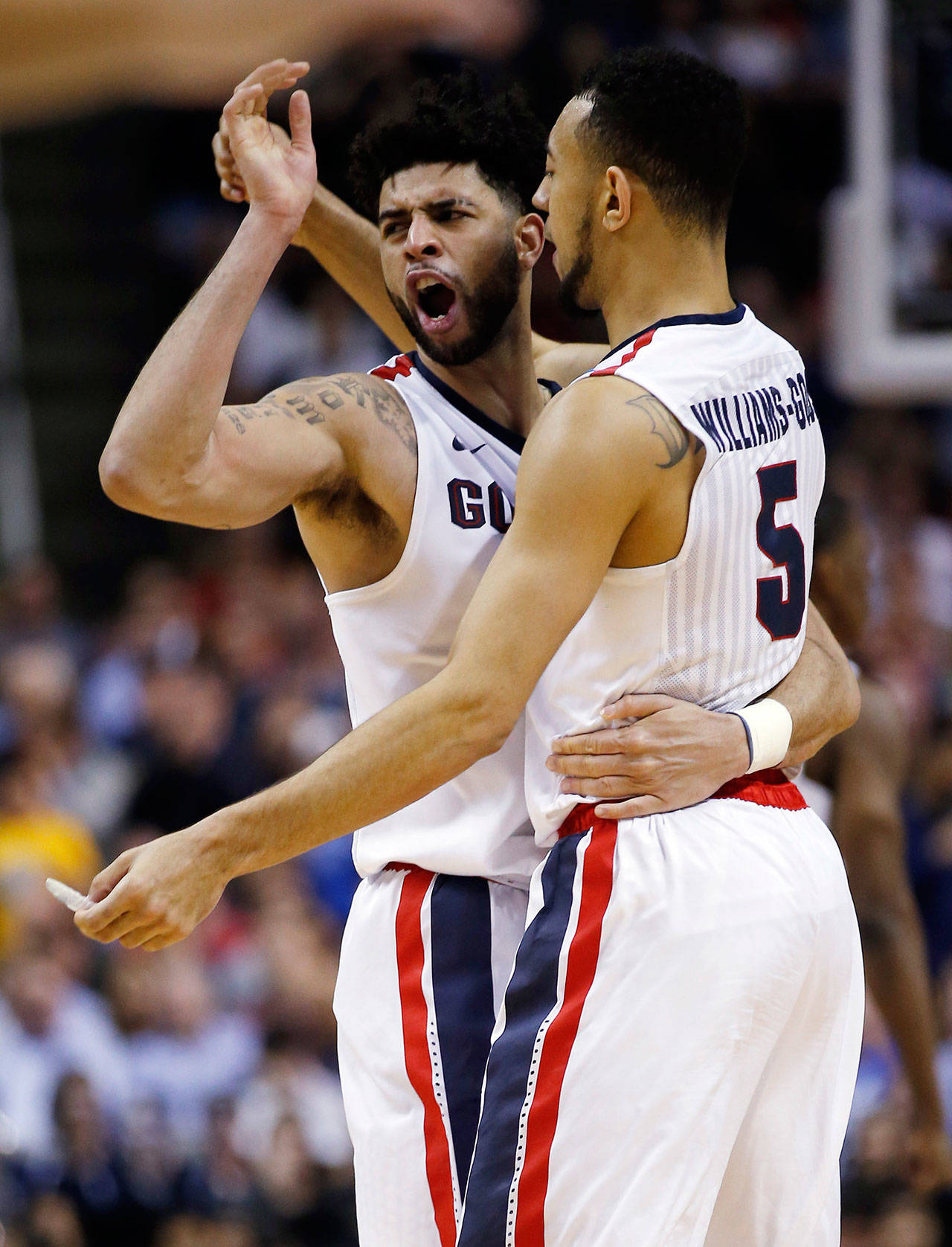 Gonzaga guard Josh Perkins (left) celebrates with teammate Nigel Williams-Goss after a win over West Virginia in an NCAA Tournament game March 23, 2017, in San Jose, Calif. (AP Photo/Tony Avelar)