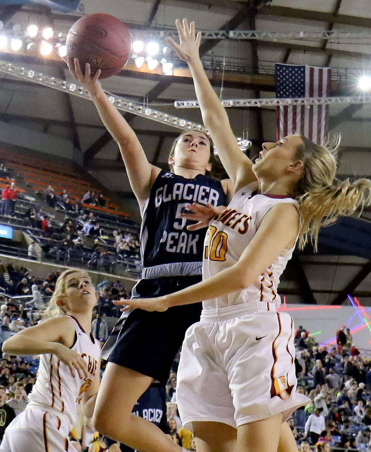 Glacier Peak’s Samantha Fatkin attempts a shot with Moses Lake’s Jessica Olson defending during a 4A state tournament semifinal game on March 3, 2017, at the Tacoma Dome. Glacier Peak won 55-51 to advance to the state finals. (Kevin Clark / The Herald)