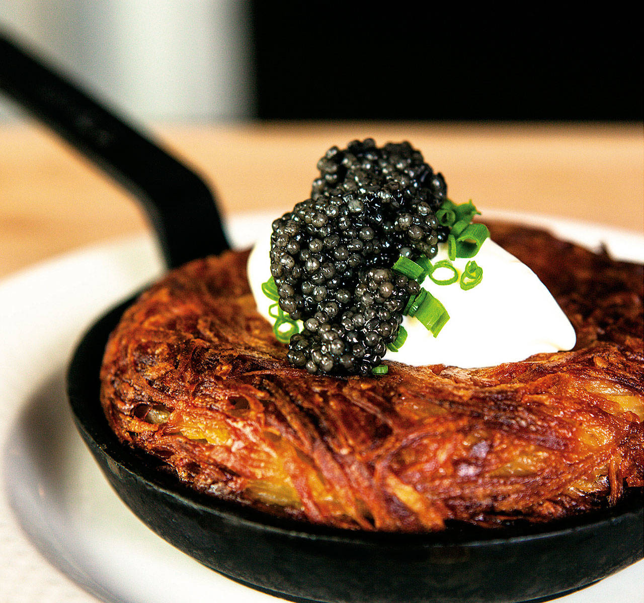 These rosti potatoes   with clabber cream and paddlefish caviar are made using mini frying pans at Seattle’s Lark restaurant. (Zack Bent photo)