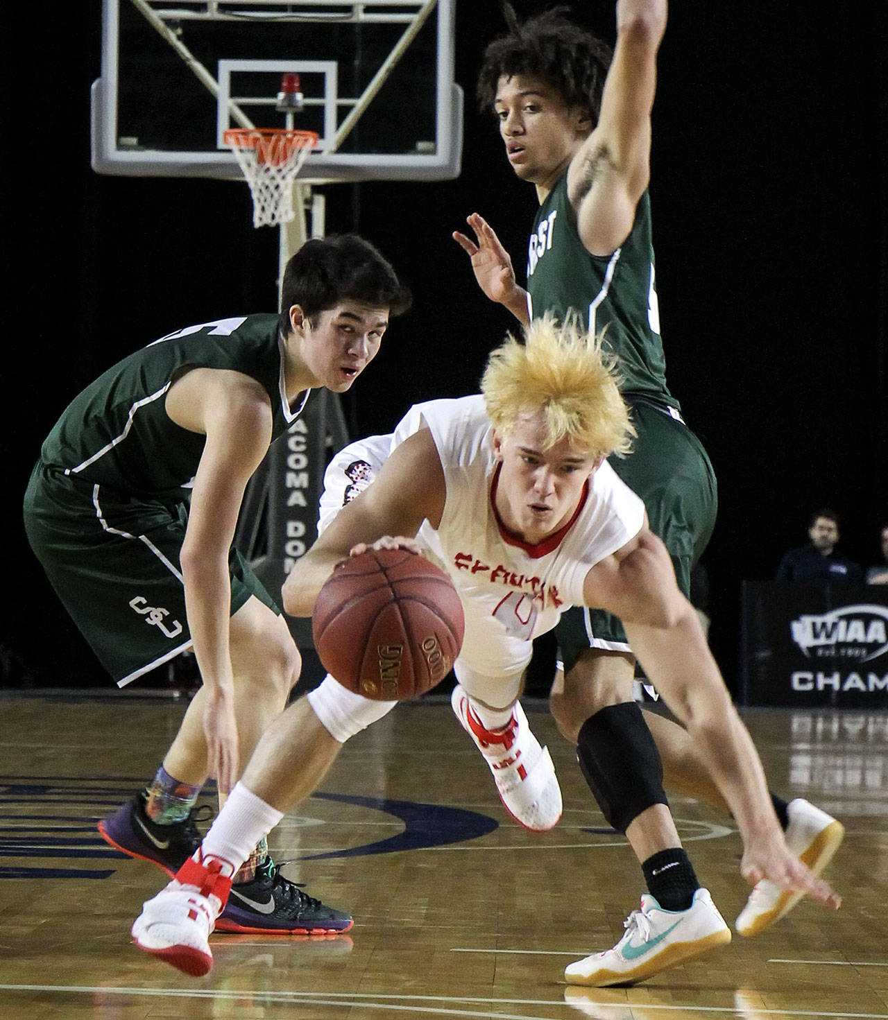 Stanwood’s AJ Martinka attempts to split the defensive pressure of Shorecrest’s Chris Lee (left) and Malcolm Rosier-Butler during a 3A Hardwood Classic tournament game March 1 at the Tacoma Dome. Stanwood defeated Shorecrest 64-52. (Kevin Clark / The Herald)