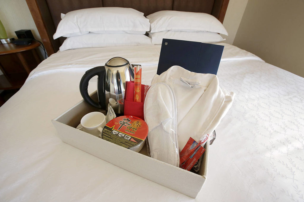 In this March 23 photo at the Sheraton Boston Hotel, items that many Chinese travelers expect in their rooms include an electric kettle, green tea, instant noodles, slippers and a robe. (AP Photo/Steven Senne)
