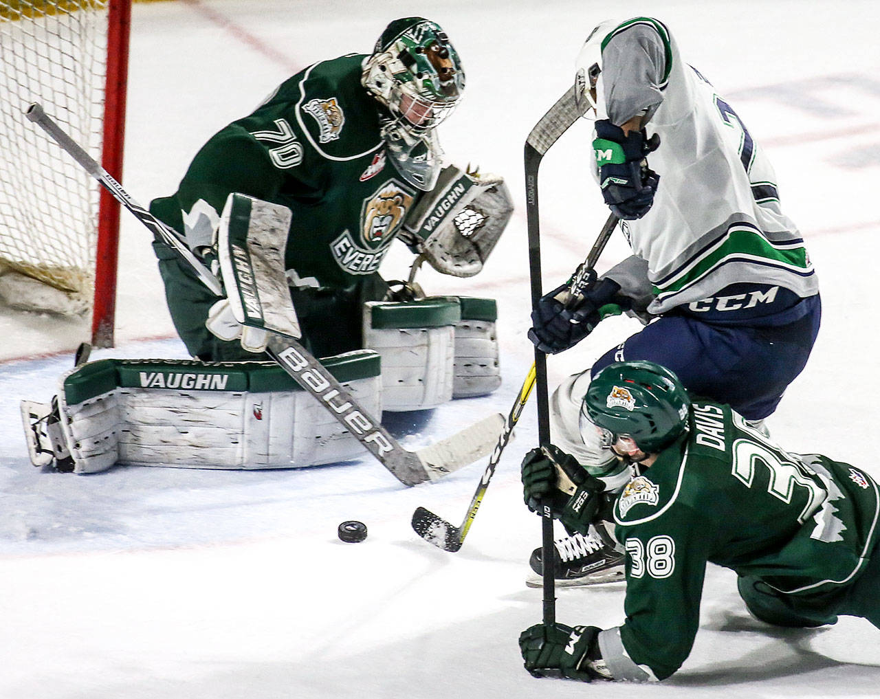 Silvertips goalie Carter Hart (left) and defenseman Kevin Davis try to stop Seattle’s Austin Strand in the second period on March 10, 2017, in Kent. (Kevin Clark / The Herald)