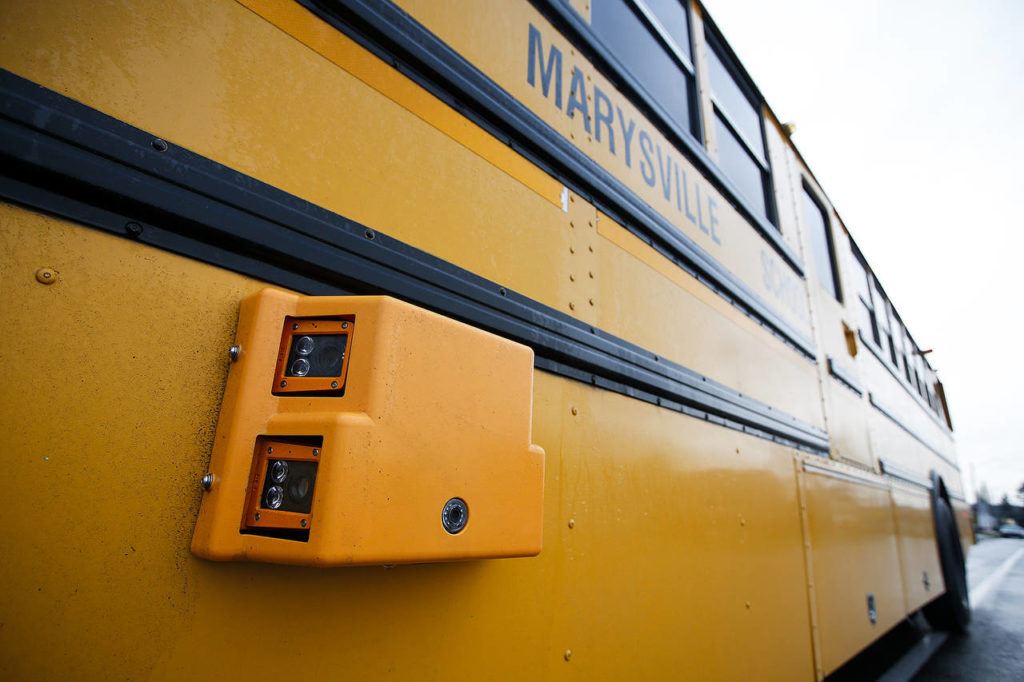 A still camera is affixed to the driver’s side of a Marysville school bus. The still camera captures license plates of cars who pass the bus illegally, while a video camera near the rear records a wide view of the scene. (Ian Terry / The Herald)
