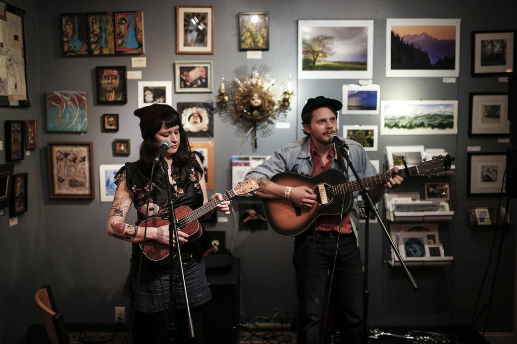 Christa and Richard Porter, The Porters, play a set at the Black Lab Gallery during the Fisherman’s Village Music Festival in Everett on Friday. (Ian Terry / The Herald)
