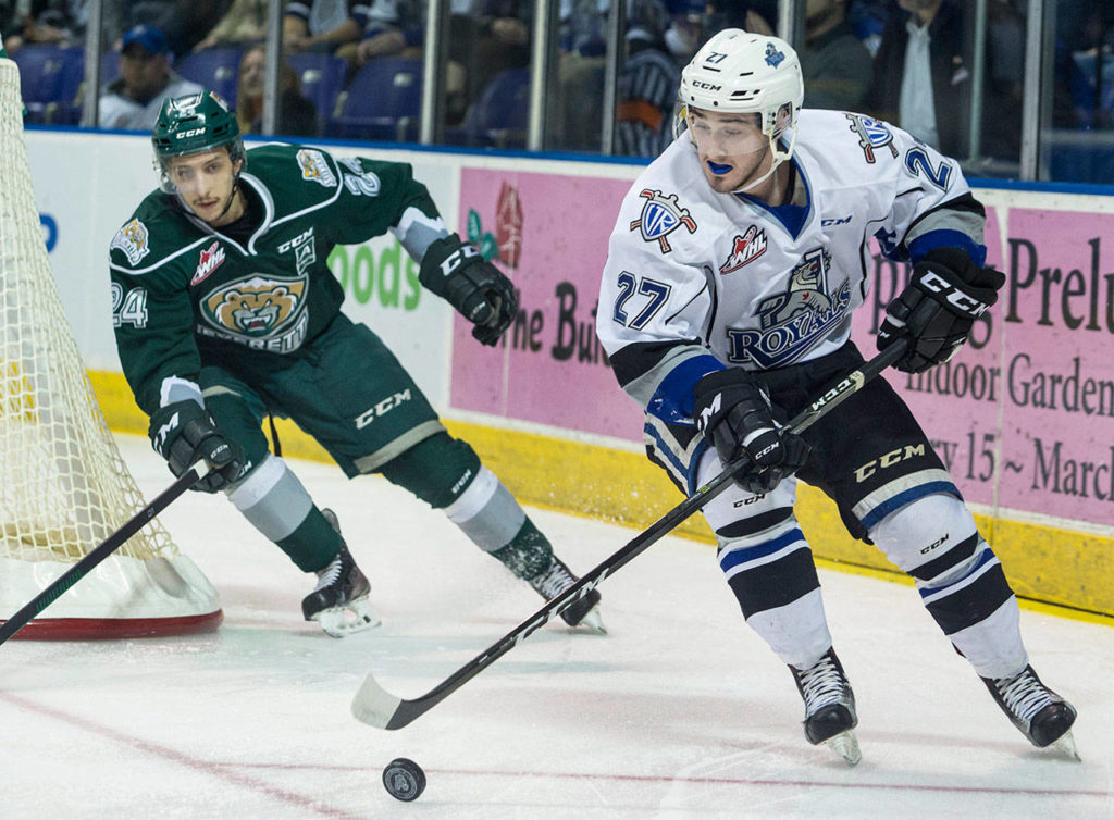 The Royals’ Jared Dmytriw skates with the puck past the Silvertips’ Lucas Skrumeda during a playoff game on March 29, 2017, Victoria, B.C. (Darren Stone / Times Colonist)
