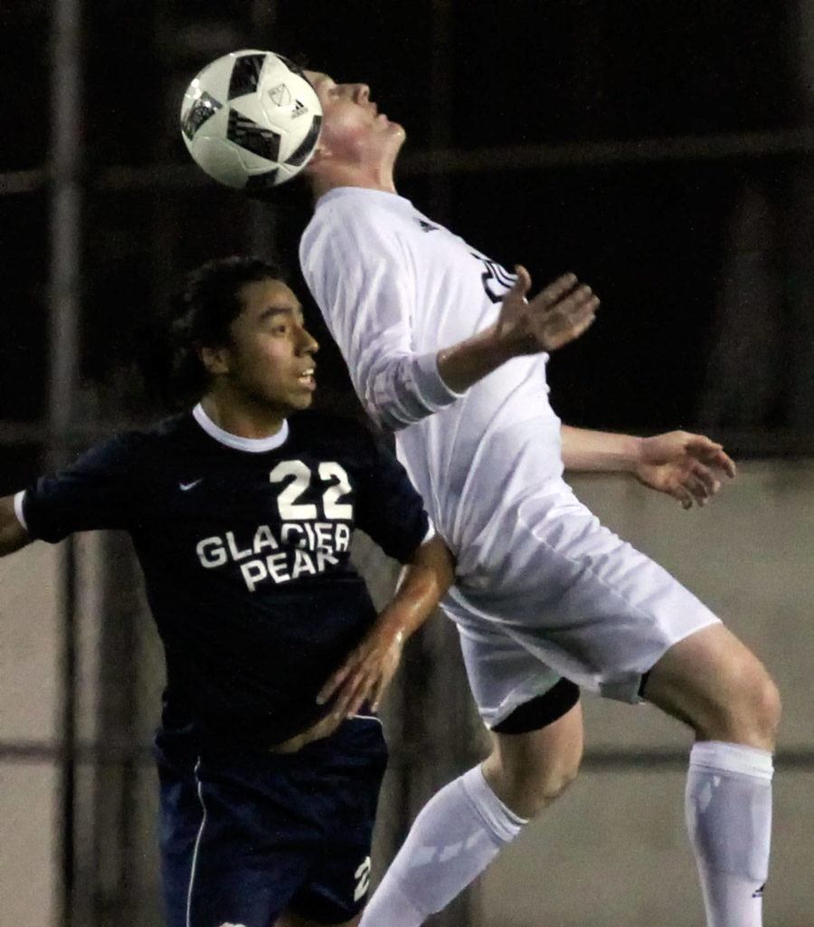 Snohomish’s Jason Fairhurst heads the ball against Glacier Peak’s Mark Granados during a match on March 17, at Veteran Memorial Stadium in Snohomish. (Kevin Clark / The Herald)
