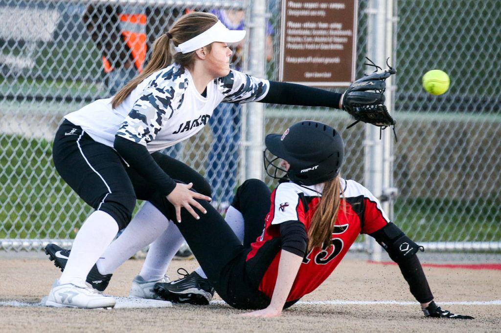 Snohomish’s Rylie Wales beats a throw to Jackson’s Kassidi Dean at third base during a game on March 16, 2017, at Valley View Middle School in Snohomish. Jackson won 3-1. (Kevin Clark / The Herald)
