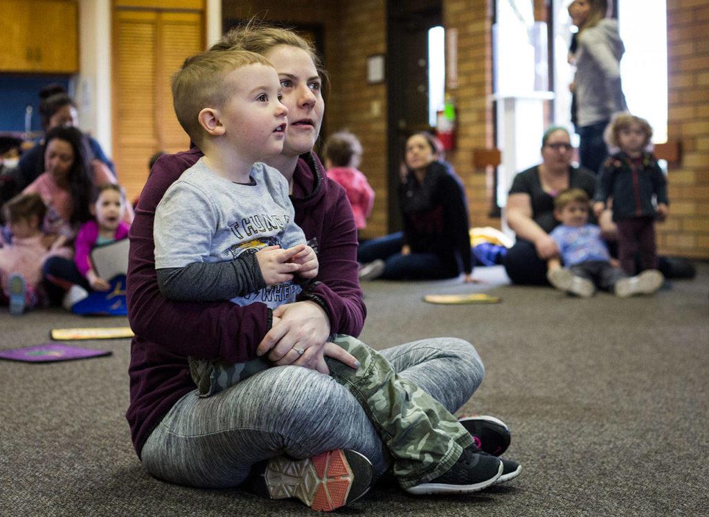 Allie Laplaunt and her 2-year-old son, Landon, listen to a story during Ready Readers: Toddler Storytime hosted by the Lake Stevens Library at the neighboring Community Center on Tuesday. The library utilizes the large space in the community center for events and readings. (Daniella Beccaria / The Herald)
