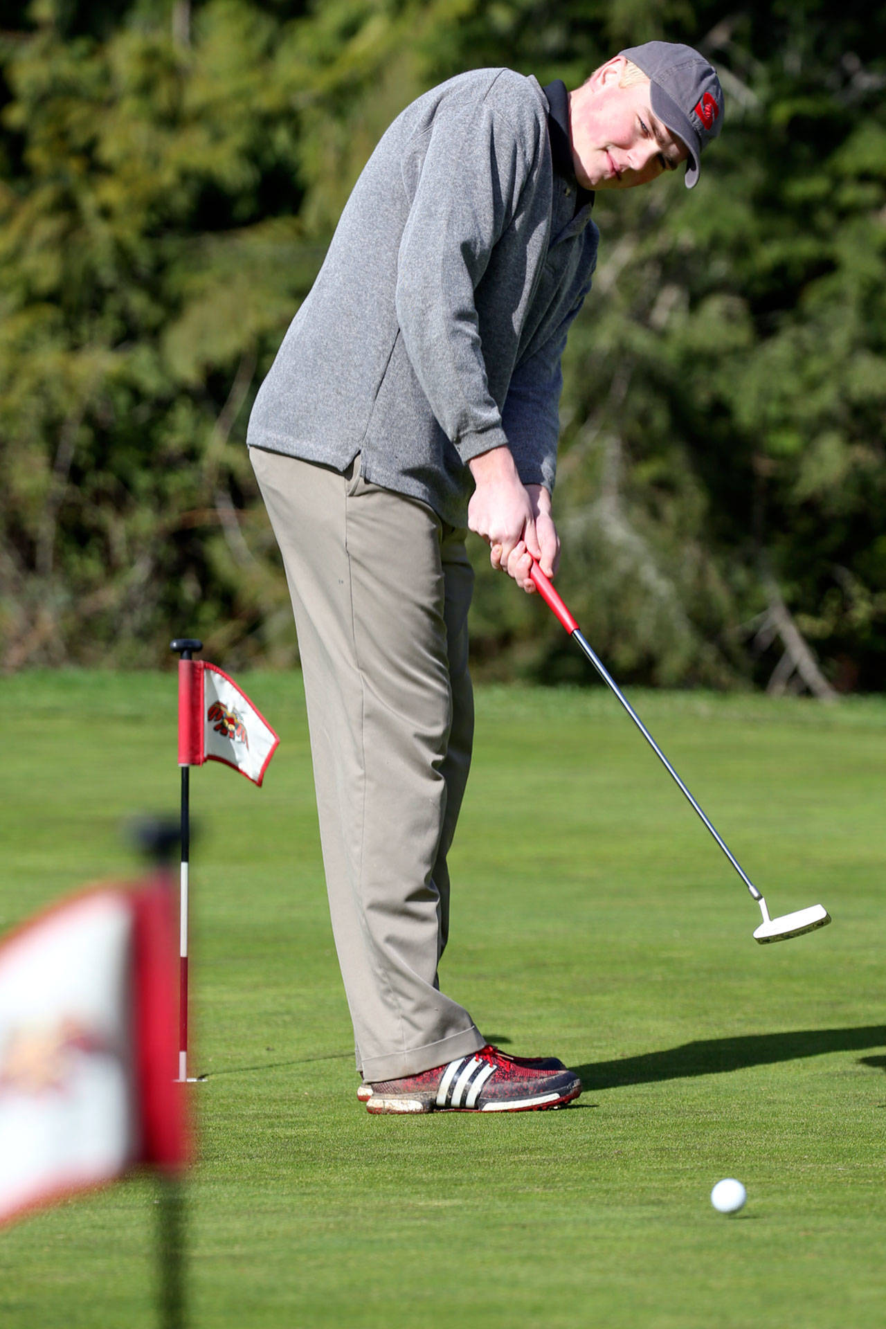 Stanwood golfer Quinton Borseth practices at Kayak Point Golf Course in Stanwood on March 16. (Kevin Clark / The Herald)