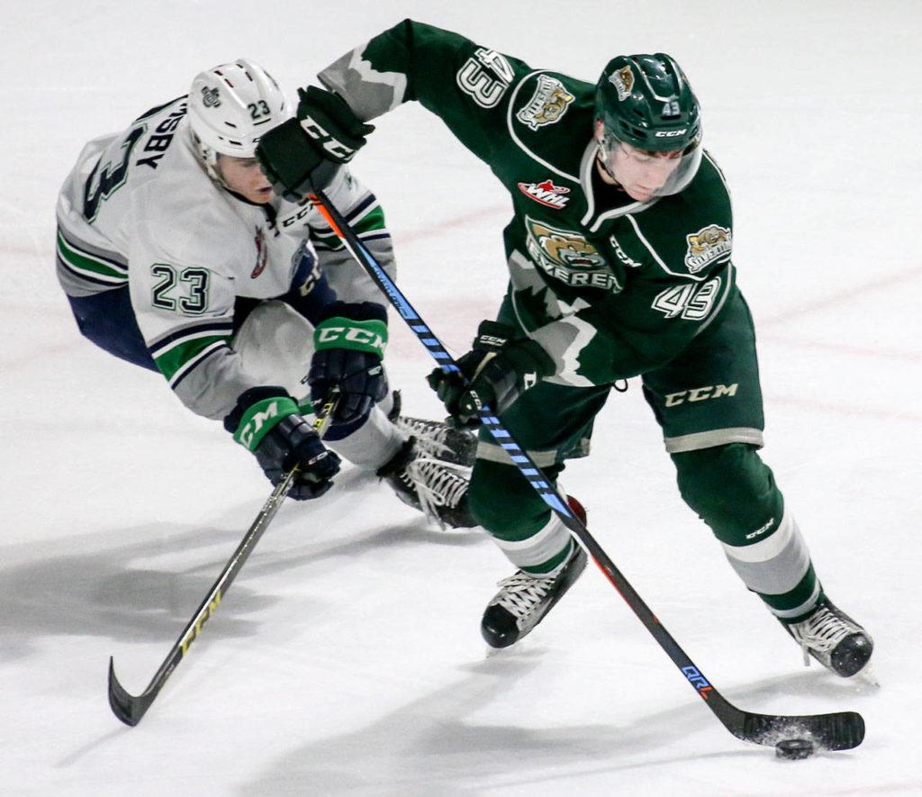 Everett’s Connor Dewar controls the puck with Seattle’s Luke Ormsby trailing during a game March 10, 2017, at ShoWare Center in Kent. (Kevin Clark / The Herald)
