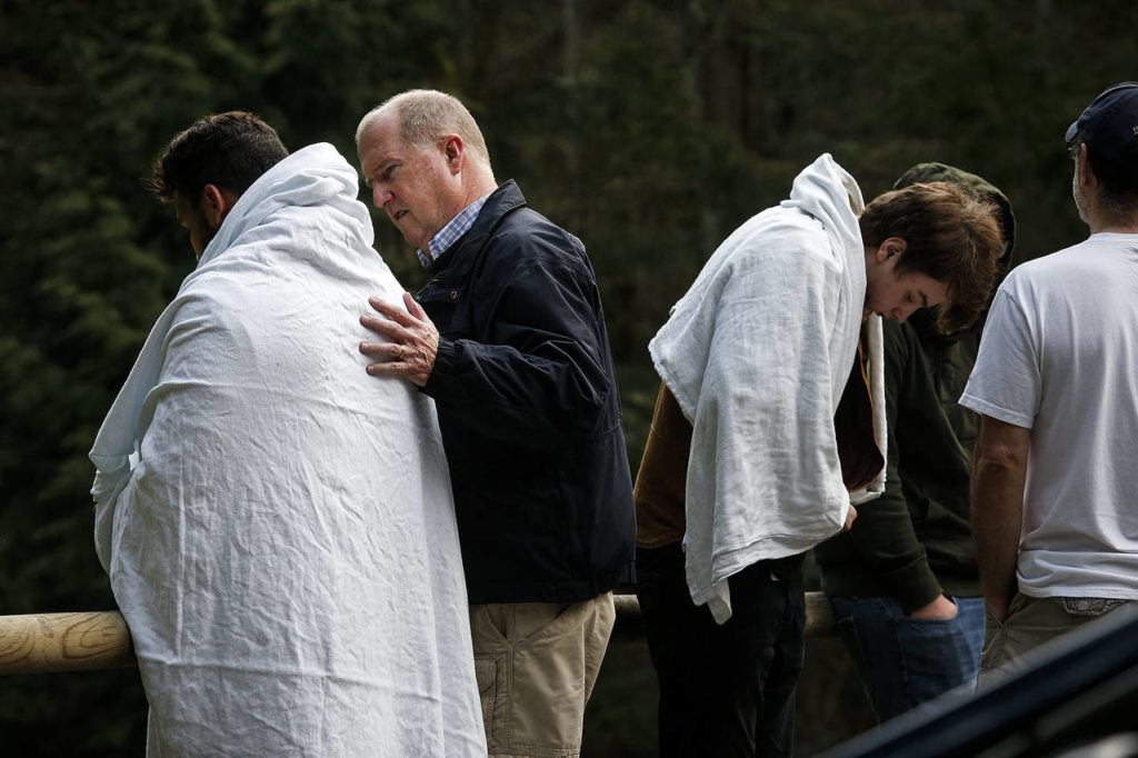 Lynnwood Police Chaplain Dale Schlack (center left) speaks with a friend of the girl. (Ian Terry / The Herald)
