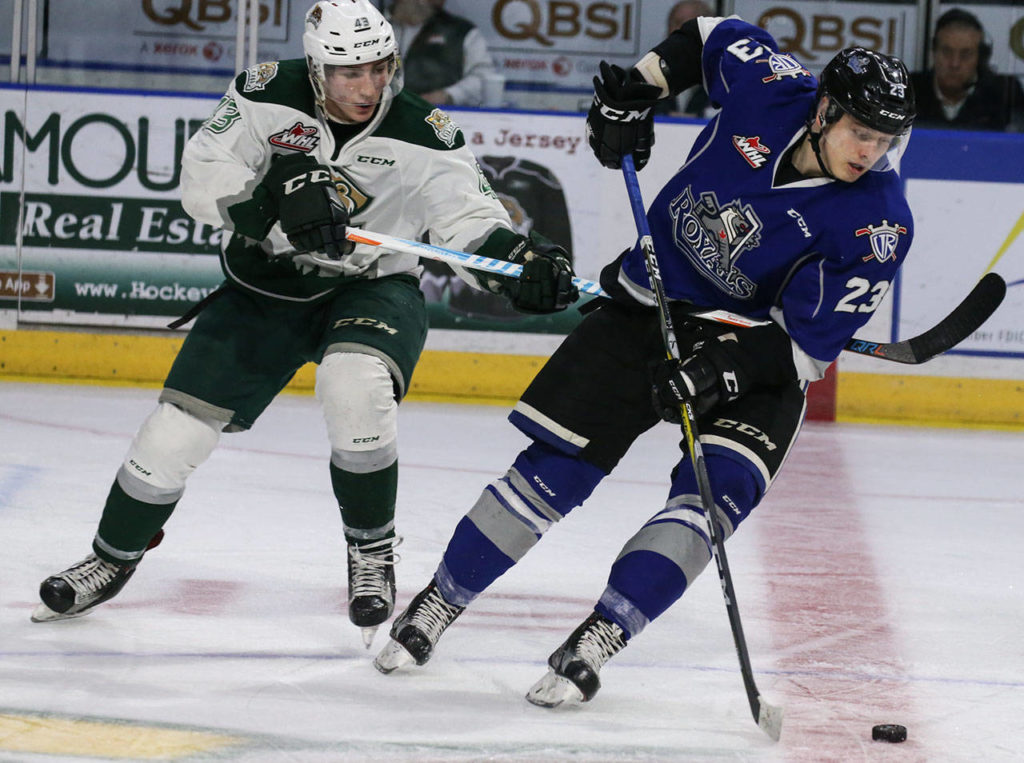 Everett’s Connor Dewar battles Victoria’s Vladimir Bobylev in the second period of a playoff game on march 25, 2017, at Xfinity Arena in Everett. (Kevin Clark / The Herald)
