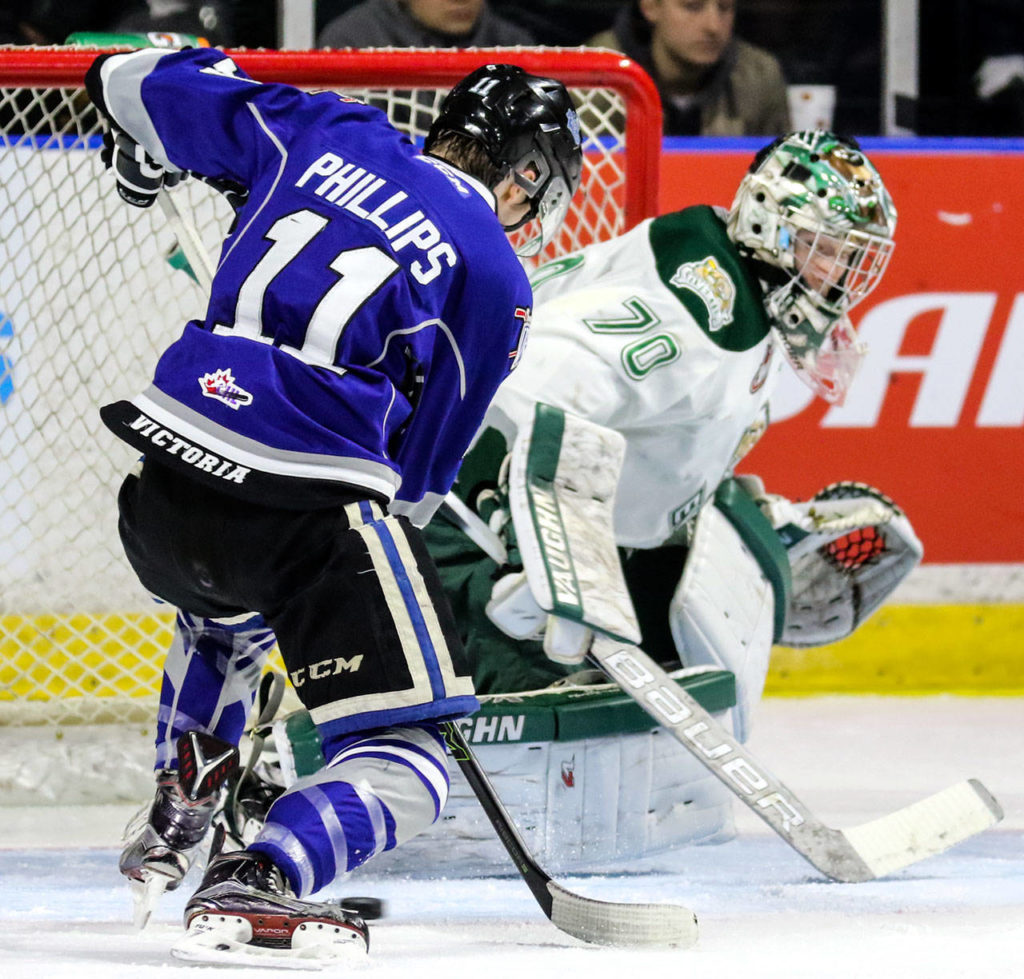 Victoria’s Matthew Phillips takes a shoat at goal with Everett’s Carter Hart defending during a playoff game March 31, 2017, at Xfinity Arena in Everett. (Kevin Clark / The Herald)
