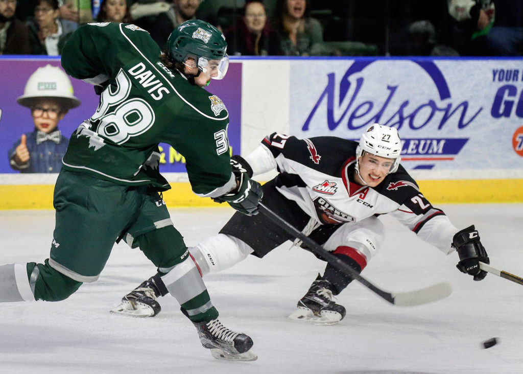 The Silvertips’ Kevin Davis attempts a shot with the the Giants’ Brendan Semchuk defending during a game Sep. 24, 2016, at Xfinity Arena in Everett. (Kevin Clark / The Herald)
