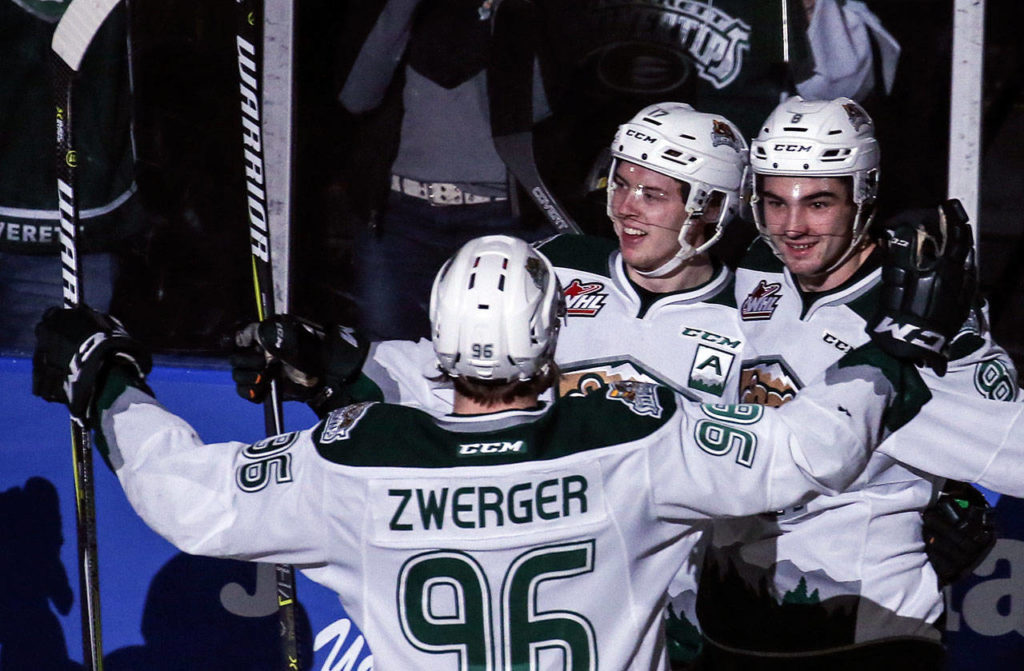 Everett’s Dominic Zwerger, Matt Fonteyne (center) and Patrick Bajkov (right) celebrate a goal in the first period of a playoff game on March 25, 2017, at Xfinity Arena in Everett. (Kevin Clark / The Herald)
