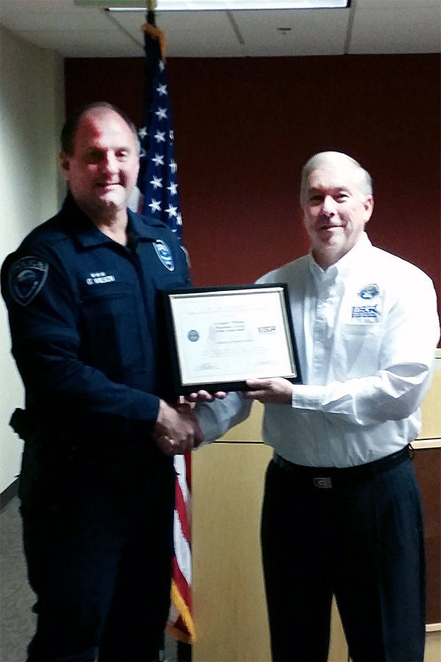 Mountlake Terrace Police Chief Greg Wilson receives a Patriotic Employer Award from Mike Kidd, Captain USN (Ret). (Contributed photo)