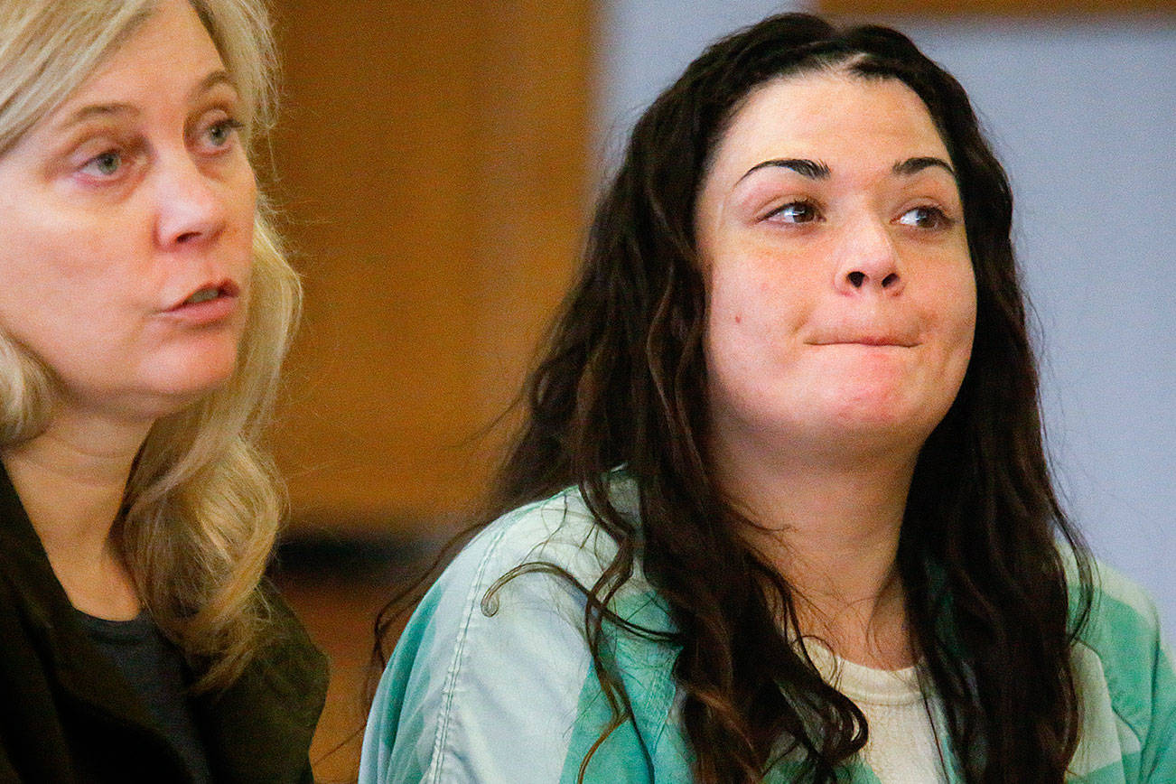 Snohomish County public defender Jennifer McIntyre discusses details of sentencing Thursday with Superior Court Judge Linda Krese as Gabrielle Waller listens.Waller will have 13 months remaining on her 20-month sentence when she returns to jail for selling heroin to Ian Digre. She refusedthe opportunity to speak to his family. (Dan Bates / The Herald)